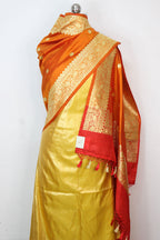 Yellow Plain Soft Tissue Katan Silk Suit With Orange Handloom Banarasi Pure Katan Silk Dupatta - Luxurion World